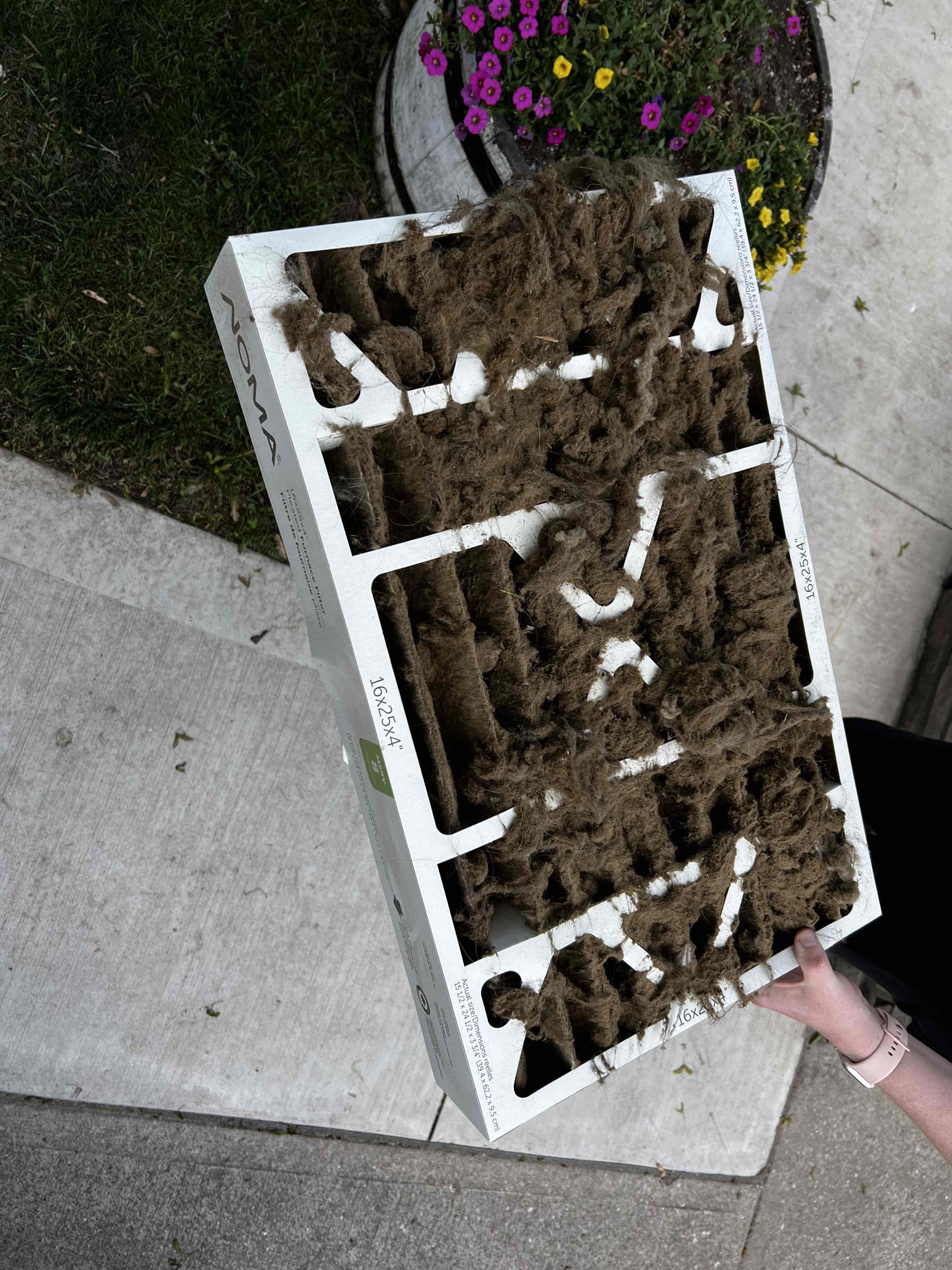 Dirty HVAC air filter packed with dust and debris