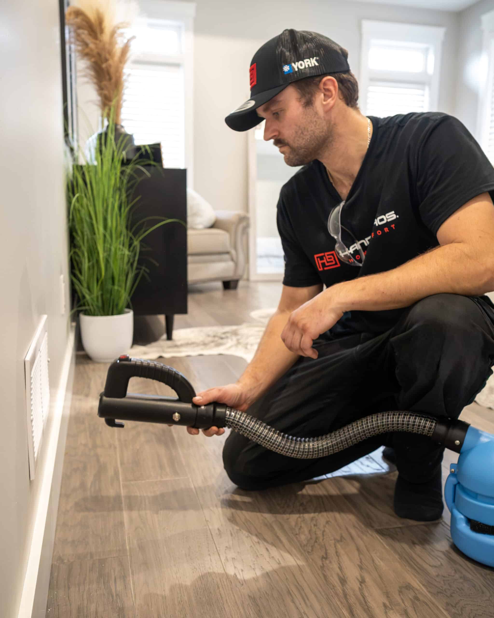 Handy Bros technician cleaning ductwork inside a home