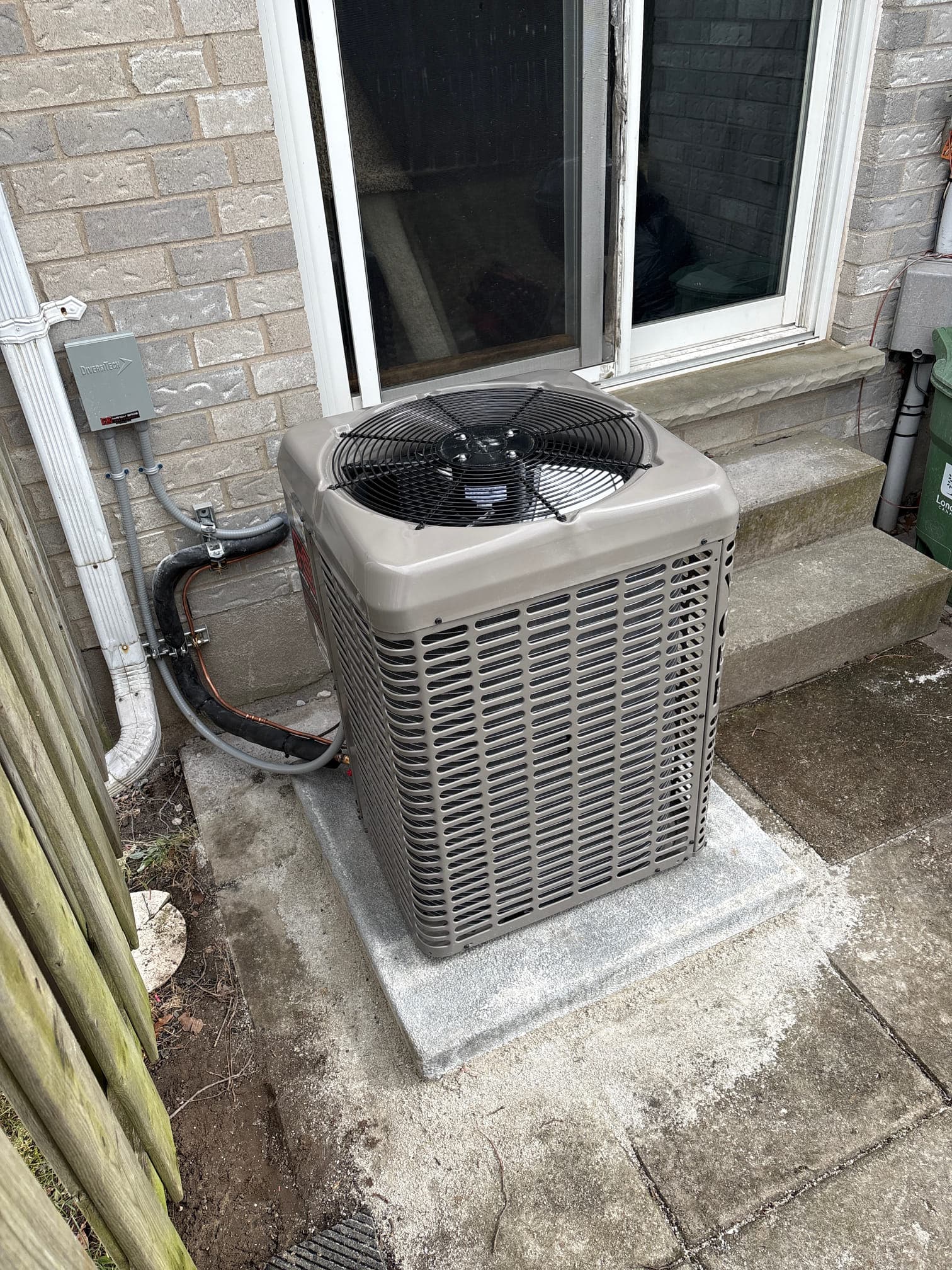 Outdoor air conditioner unit beside a home