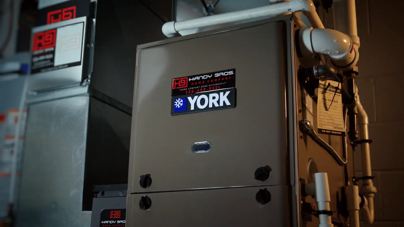 A Handy Bros. technician installing a furnace, ensuring proper setup for efficient and reliable home heating.